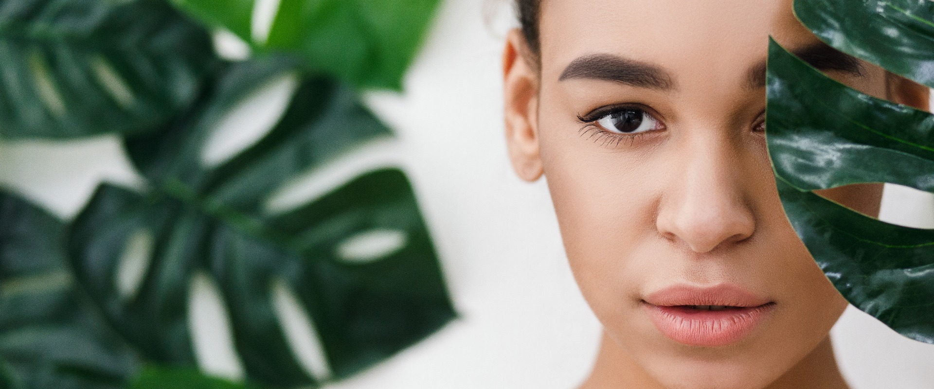 Natural cosmetics african american woman against tropical leaves jpg